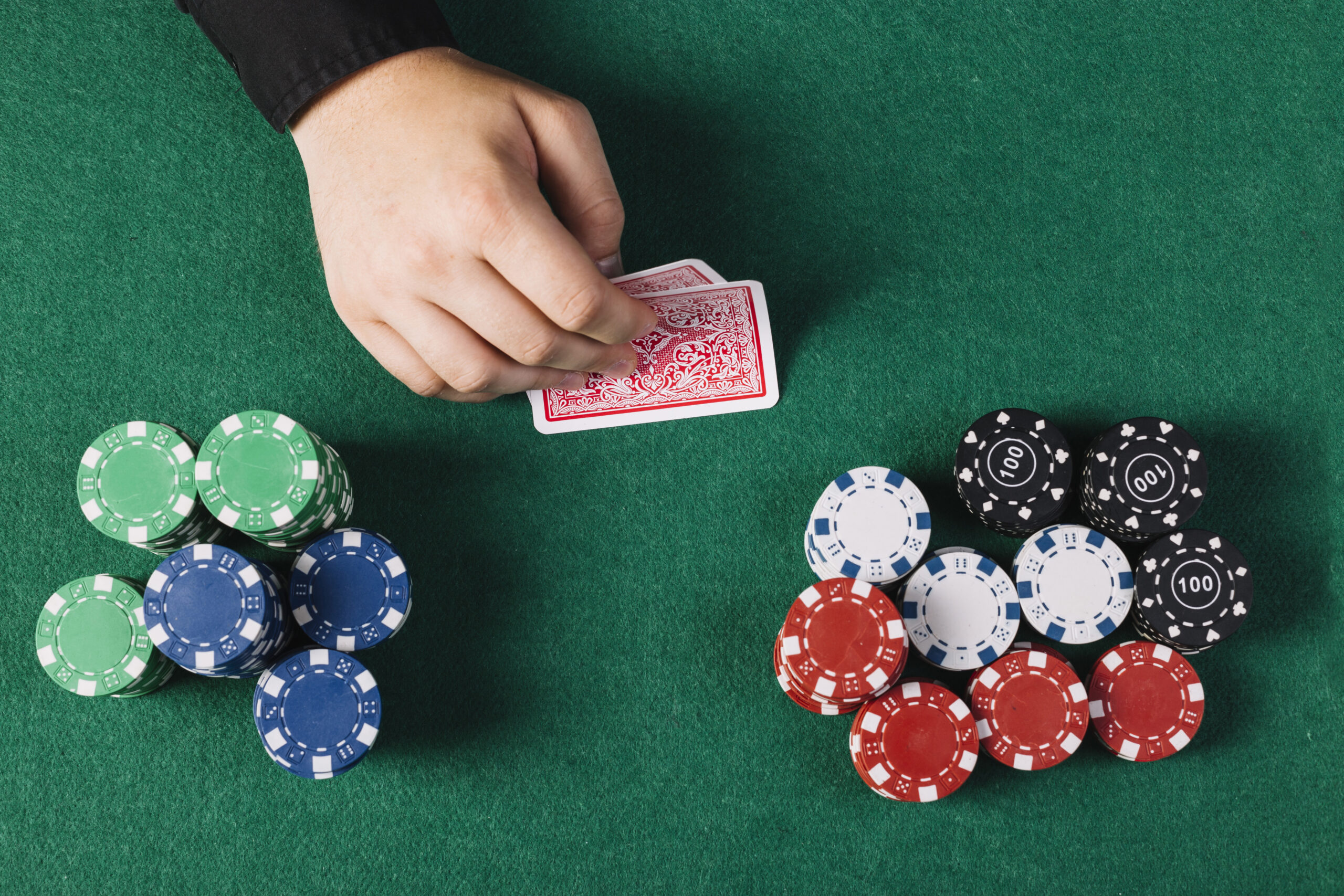 high angle view player s hand with playing cards near poker table scaled Home